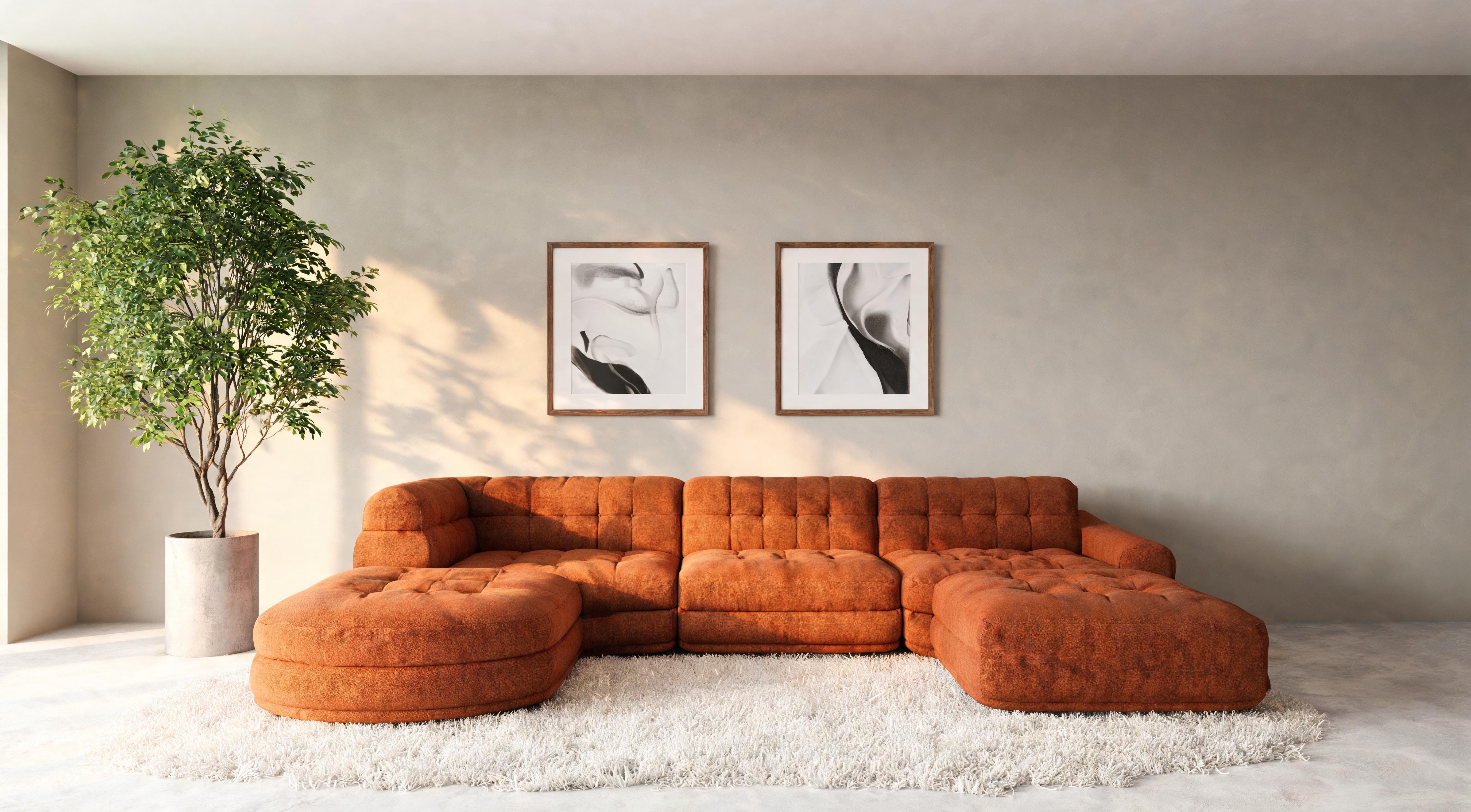 A considered living room with a well-proportioned sofa, side table and cushions in warm natural light